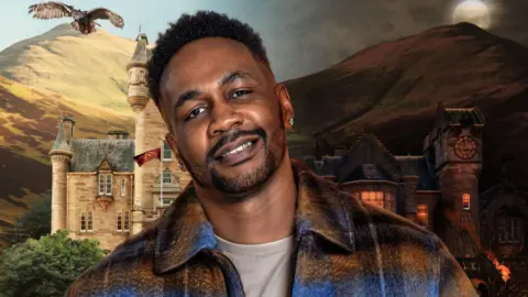 A head shot of Leon Jackman with a picture of a castle behind him. 