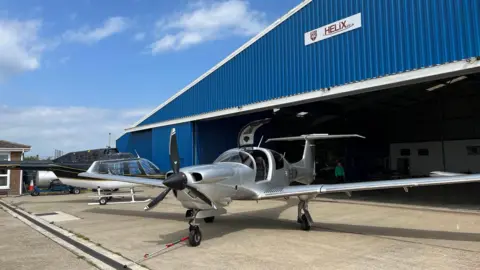 A small aircraft outside a hanger at Manston