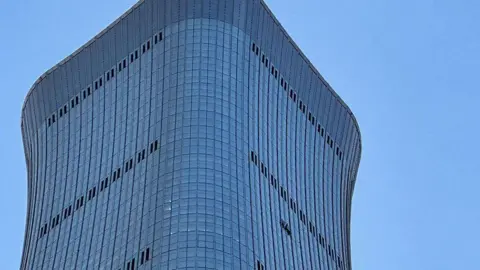 Getty Images The top of the CITIC Tower in Beijing China showing a hole on its side where a small plane crashed