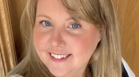 Michelle Jones A selfie of Michelle Jones in front of a door