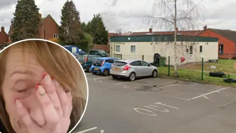 LDRS Councillor Milly Boylan, with her face in her hand, looking tired, pictured next to the single-storey, white shelter building.