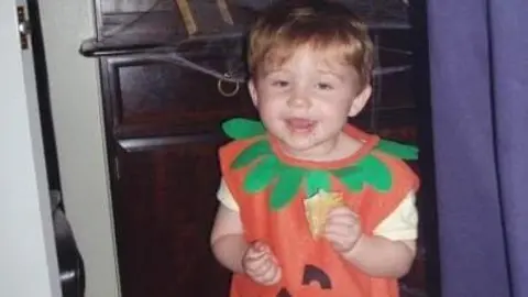 Family handout A family photo of Ellis as a Toddler dressed in a Pumpkin costume