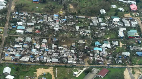 Getty Images Houses destroyed in the wake of a major cyclone that hit Vanuatu