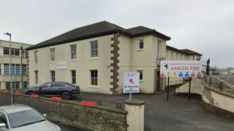 A street view of Angus Fire in Bentham. The two-storey building is painted in vanilla with a sign at the front that reads "Welcome to the home of Angus Fire".