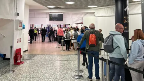 Lisa Ruston Queues at Birmingham Airport