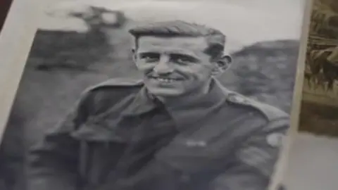 Family handout Tony Johnson smiles for the camera in his uniform during World War Two