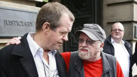 PA Media Michael Hamilton (left), father of Vicky Hamilton, and Ian McNicol, father of Dinah McNicol, outside the High Court in Edinburgh in 2010.