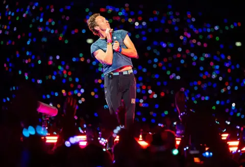 Getty Images Chris Martin of Coldplay, surrounded by fans at Wembley Stadium