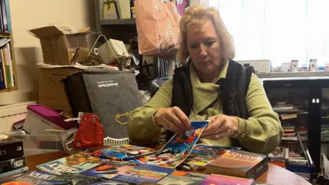 Tina Walford preparing an advent calendar made of books.