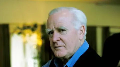 Getty Images John le Carré in a shirt looking serious