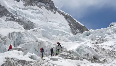 Photo showing five climbers practising at Khumbu Icefalls area before Camp I. 