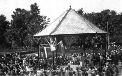 Black & white old image of a crowd around the bandstand