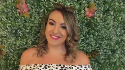 Steve James a young woman with curly brown hair smiling