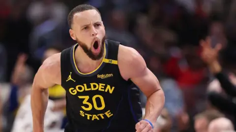 Stephen Curry of the Golden State Warriors celebrates a three pointer against the Chicago Bulls during the second half at the United Center in Chicago
