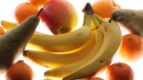 Barnaby Perkins/BBC A bunch of bananas with an apple, oranges and pears.