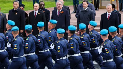 EPA-EFE/Shutterstock Leaders, including Belarus President Alexander Lukashenko, Russian President Vladimir Putin, Chinese President Xi Jinping, Tajik President Emomali Rahmon, Kyrgyz President Sadyr Japarov and Turkmen President Serdar Berdimuhamedov observe a military parade in Moscow