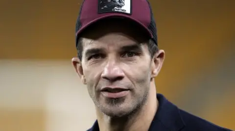 PA Media David, a man, with a subtle beard, wearing a maroon and black hat, looking into the camera. 
