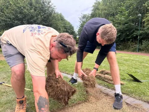 Iain and Craig pulling up turf.