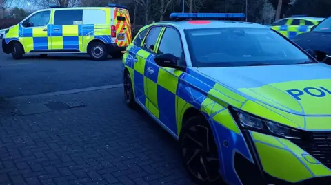 Cambridgeshire Police Multiple police vehicles parked including cars and vans 