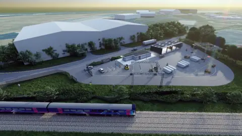 TVCA A CGI ofthe CAM testbed. A train drives along the bottom of the image. Above it stands a large white building and an outdoor testing area. There are several vehicles in the testing area as well as a testing bays.