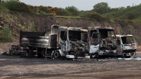 Three burnt out lorries on the Upper Springfield Road  
