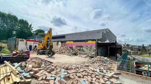 Exeter City Council Plant machinery on the demolition site of the old Clifton Hill leisure centre