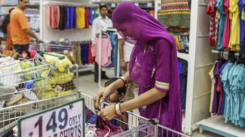 A shopper wearing a purple head scarf at women's clothing section at a D-Mart supermarket in Thane, Maharashtra, India,