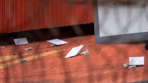 White squares on an orange tin roof