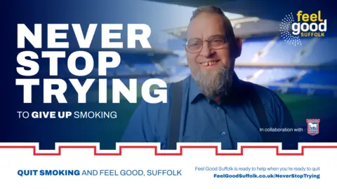 Suffolk County Council A campaign poster of Mr Shuttleworth smiling at the camera with the campaign title, Never Stop Trying written next to him.