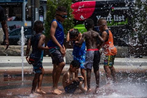 Children enjoy a splash pad on the Greenway during a heatwave in Boston, Massachusetts, on  19 June