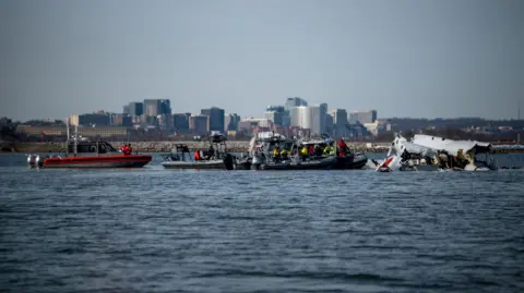 US Coast Guard/Reuters U.S. Coast Guard, along with other search and rescue teams, operate near debris at the crash site in the Potomac River in a location given as Washington, in the aftermath of the collision of American Eagle flight 5342 and a Black Hawk helicopter that crashed into the Potomac River, U.S. January 30, 2025