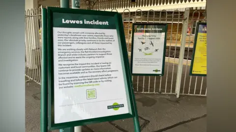 George Carden/BBC An empty Lewes train station. A sign detailing the latest on the Lewes train derailment can be seen in the station.