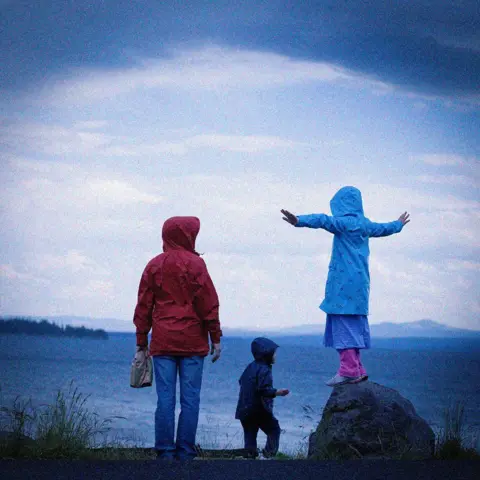Getty Images A mother with her two children by the sea