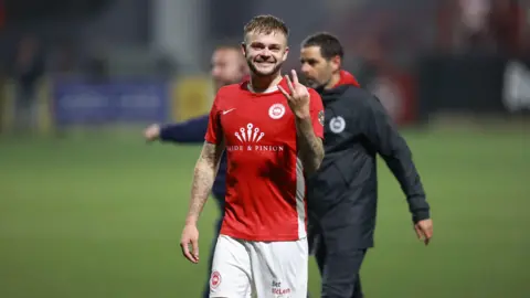 Andy Ryan, post-game, holding up three fingers