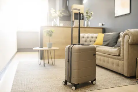 Getty Images Suitcase in holiday home