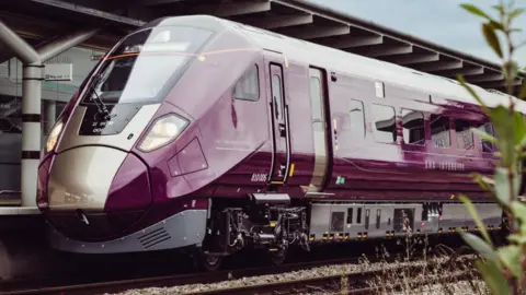 East Midlands Railway The front of a purple East Midlands Railway train on the track 