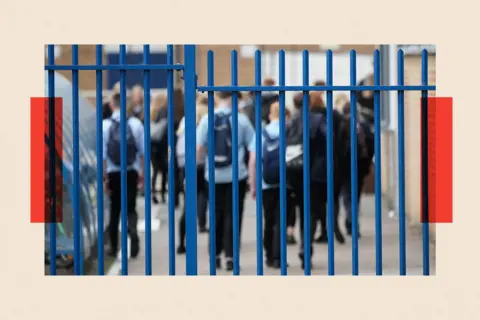 Getty Images School children walk inside a school