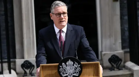Starmer speaking at a lectern in front of No 10