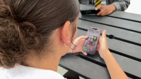 A student uses a mobile phone