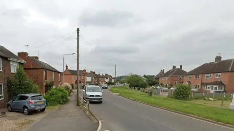 Village residential street of two storey brick semi-detached houses