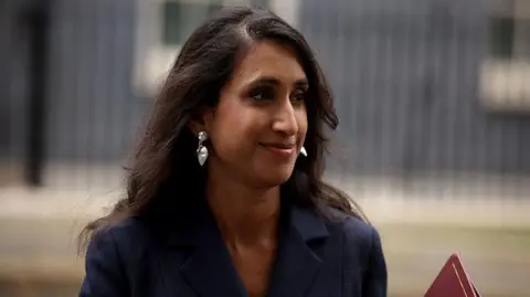 Getty Images Coutinho is seen at Downing Street in 2024. The buildings are blurred behind her. The head and shoulders shot shows her wearing silver dangly earrings and a blue jacket.