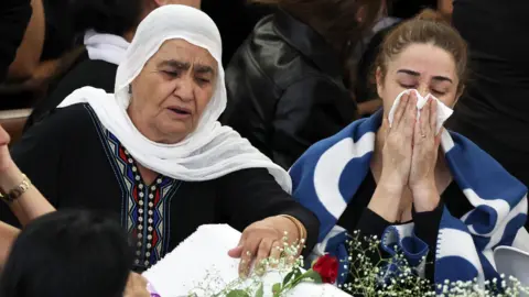 EPA Druze mourners weep over the coffin of one of the victims of a rocket attack from Lebanon, in the village of Majdal Shams (28/07/24)