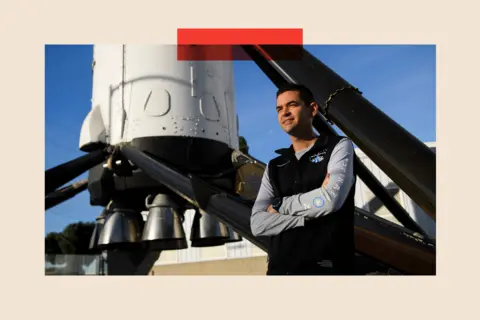 Getty Images Jared Isaacman standing in front of the recovered first stage of a Falcon 9 rocket