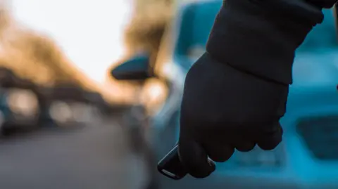 Image of man with keyless car entry unit