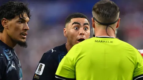 Paraguay forward Miguel Almiron reacts to Dutch referee Danny Makkelie's decision to book him for diving
