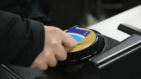 Getty Images A commuter swipes his Oyster card at a London Underground station