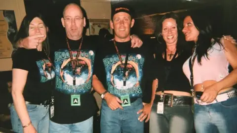 Supplied Five people in band t-shirts. 