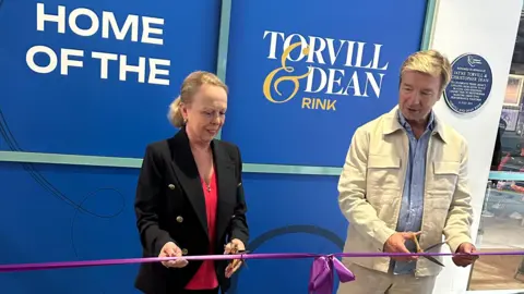 Jayne Torvill and Christopher Dean cutting a ribbon to officially rename a rink 'Torvill and Dean Rink' at the National Ice Centre, in Nottingham.