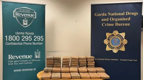 Gardai Bags of cocaine recovered by Gardaí pictured stacked on a table.