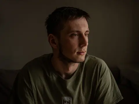 BBC Pavlo, dark dark and dressed in green t-shirt, moves away from the camera